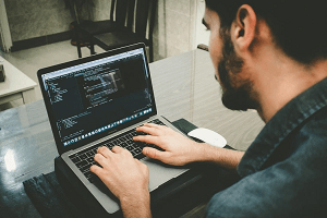 Man on computer learning how to code